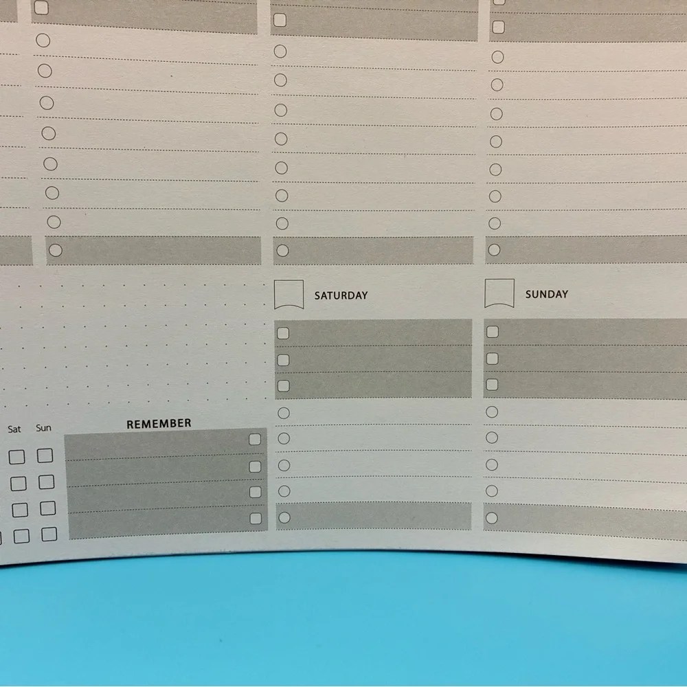 Zerone Productivity weekly planner featuring a gold spiral binding.